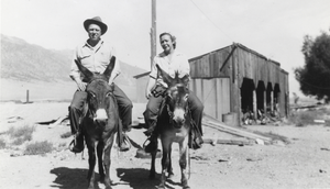 Al and Alice Lofthouse are pictured riding burros that a miner had left at the Carver Ranch: photographic print