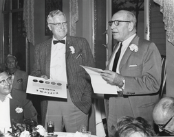 Howard Eells presenting a plaque to Norman Hanson at a Basic Refractories Employees' dinner meeting, Maple Grove, Wisconsin: photographic print