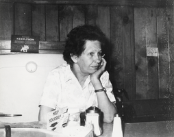 Lona Williamson behind the lunch counter at Carver's Station: photographic print