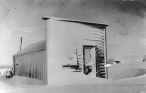 Building and snow drifts in Round Mountain, Nevada: photographic print