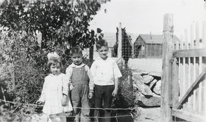 Getta Berg, Dan Berg and a boy named Carroll in the front yard of the Berg Home, Nevada: photographic print