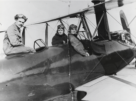 Thomas, Georgetta, and Will Berg, taking a ride in a Travelair biplane piloted by Garland Lincoln and stunt pilot Walter "Suicide Slim" Cahill: photographic print