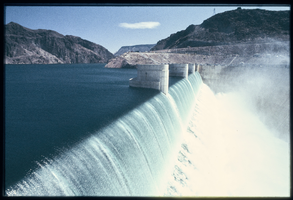 Water flows over the Arizona spillway, looking north-northwest at Hoover Dam, Arizona: photographic slide