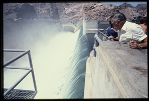 A man watches water flowing down the Arizona spillway, looking south at Hoover Dam, Arizona: photographic slide
