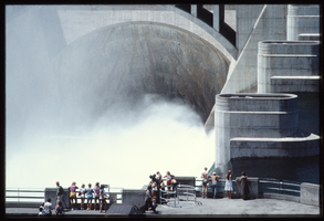 People gather to watch water flowing down the Arizona spillway, looking south at Hoover Dam, Arizona: photographic slide