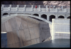 People use the bridge over the Arizona spillway to get a look at overflow water, looking southwest at Hoover Dam, Arizona: photographic slide