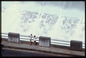 Children watch the overflow water in the Arizona spillway, looking west at Hoover Dam, Arizona: photographic slide