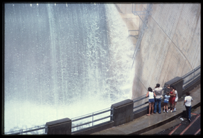 A family watches the overflow water in the Arizona spillway, looking west at Hoover Dam, Arizona: photographic slide
