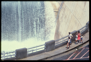 A family watches the overflow water in the Arizona spillway, looking west at Hoover Dam, Arizona: photographic slide