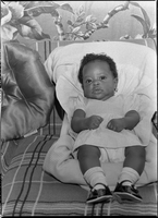 Set of photographs including Mrs. Gibbs' baby, children at 1708 Highland, Voice Party, play school at Doolittle, Minnie Wilkins painting, and football practice: image 001