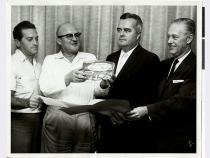 A black and white photo of Al Freeman, unspecified, and three others at the Sands Hotel in Las Vegas, Nevada. The man second fr