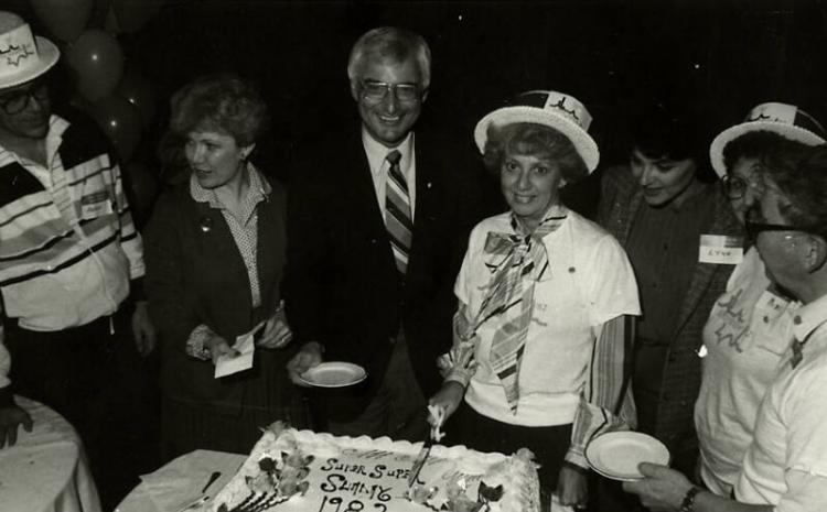 Cake cutting for Super Sunday event with Dennis Sabbath, Myrna Williams, Jim Santini, Dorothy Eisenberg (cutting cake), Lyn Rosencrantz, and Ray and Jerry Countess, 1982. MS-00731, Dennis and Roberta Sabbath Papers.