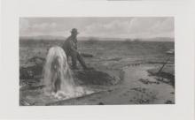 Man sitting near artesian well, probably Old Ranch