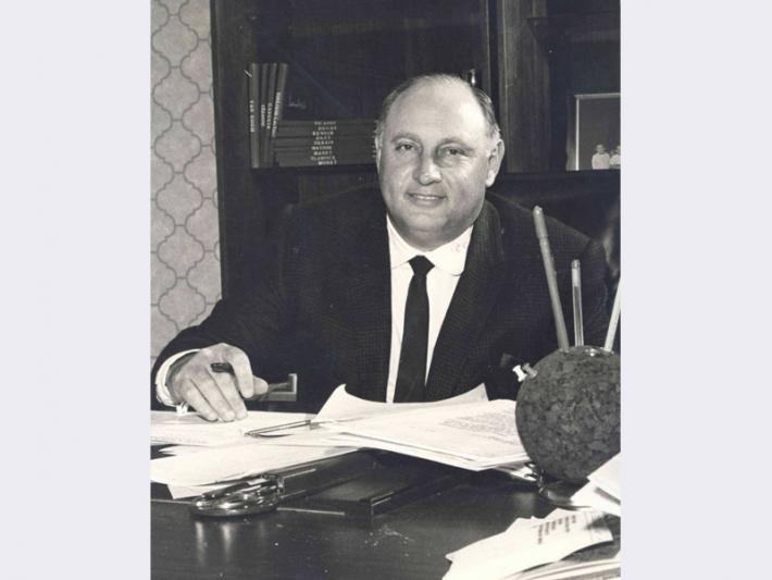 Jay Sarno seated at desk, circa 1968