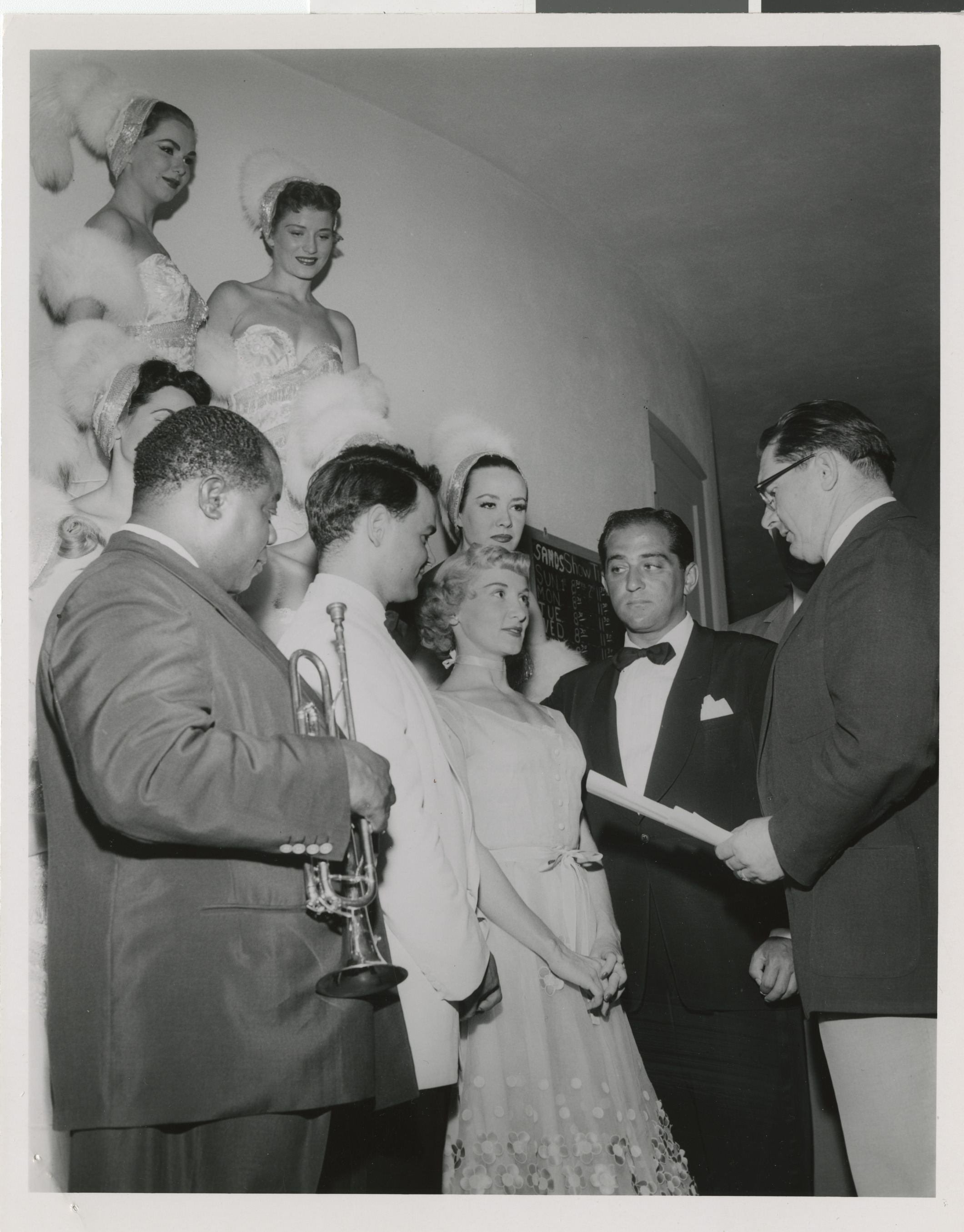 Photograph of Louis Armstrong off stage at a wedding ceremony