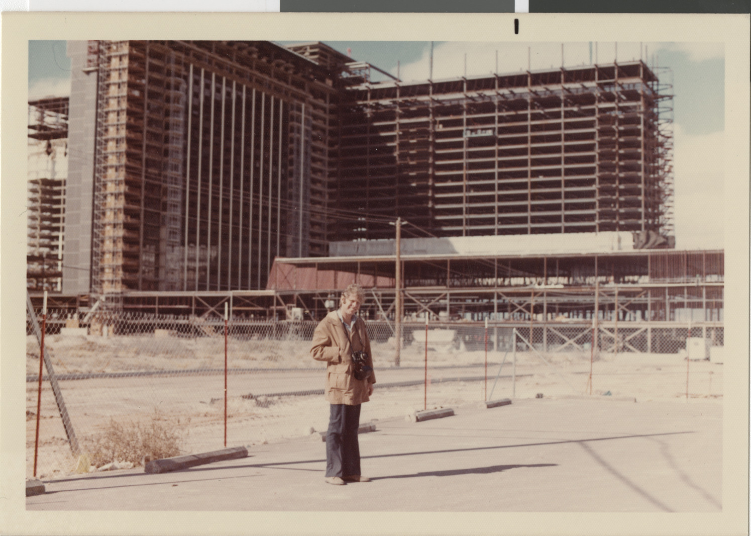 Photograph of Stuart Mason outside of MGM construction site, 1972-1973