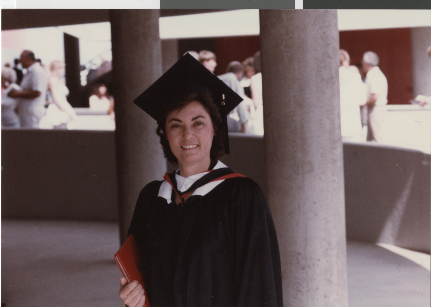 Photograph of Flora Mason in cap and gown for graduation, 1988