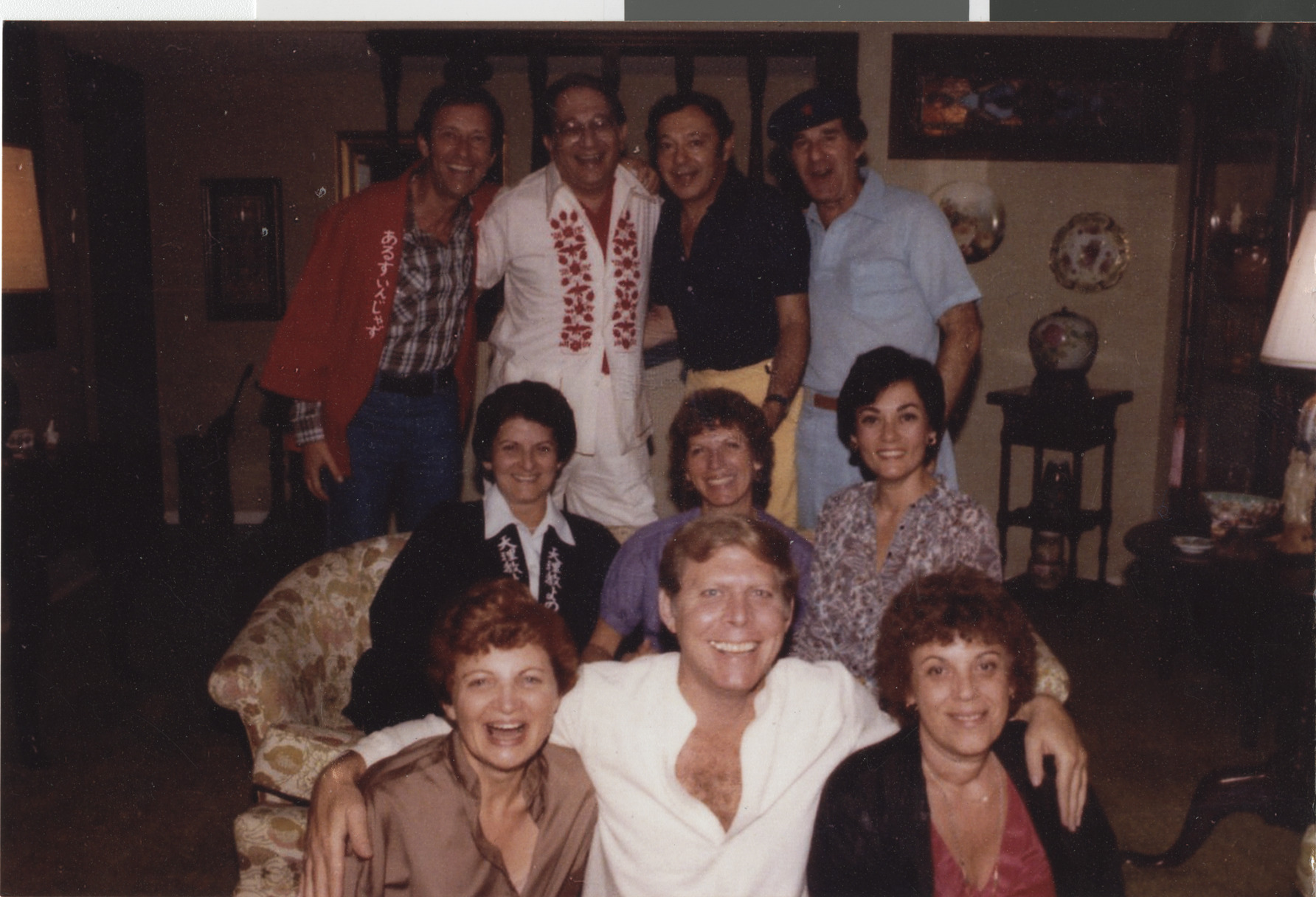 Photograph of Stuart Mason (front center) and Flora Mason (second row, right) with a group, circa 1975