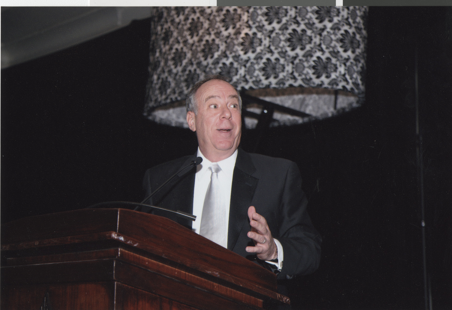 Photograph of a man at a podium, April 2008