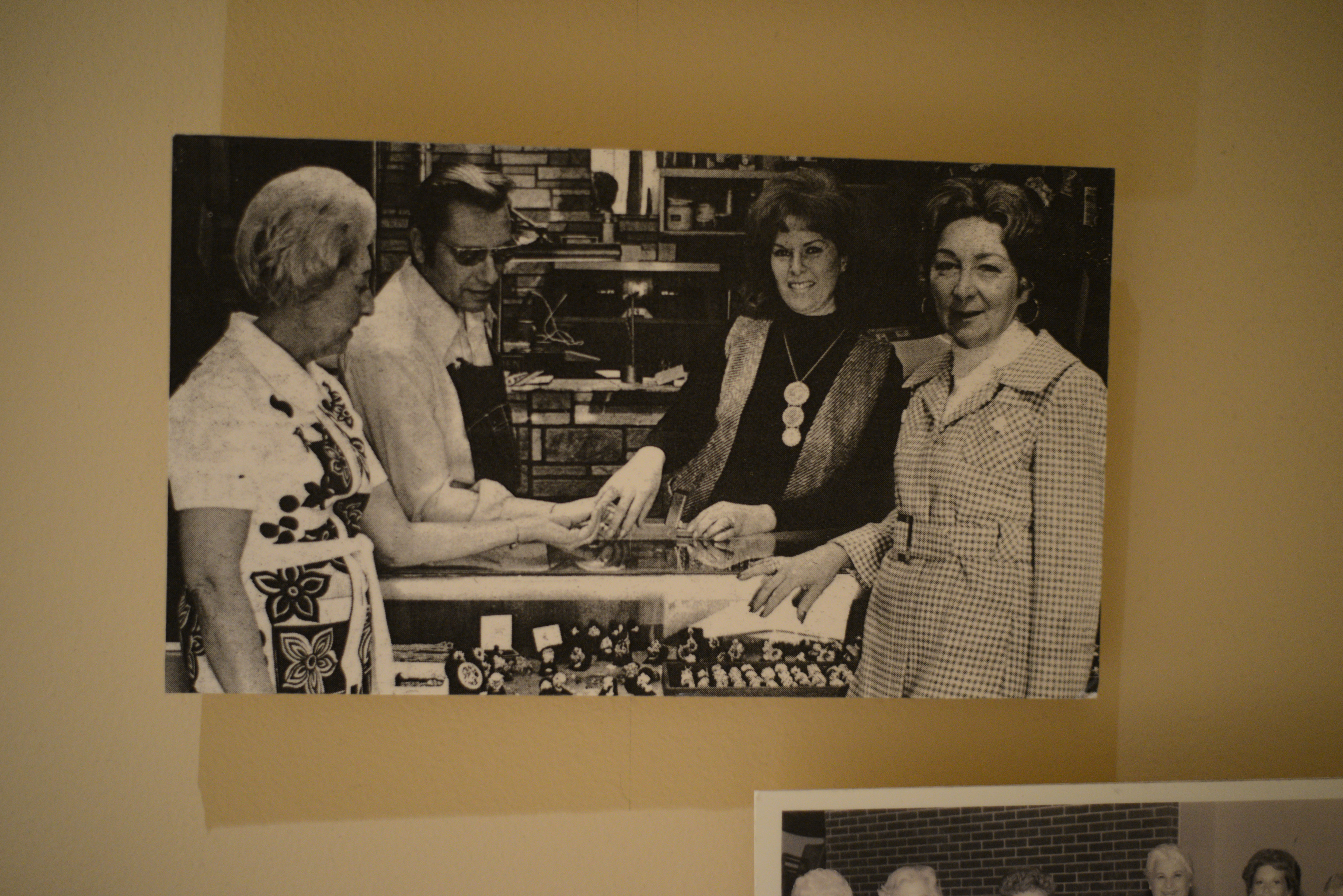 Photograph of a group of women at jewelry counter, date unknown