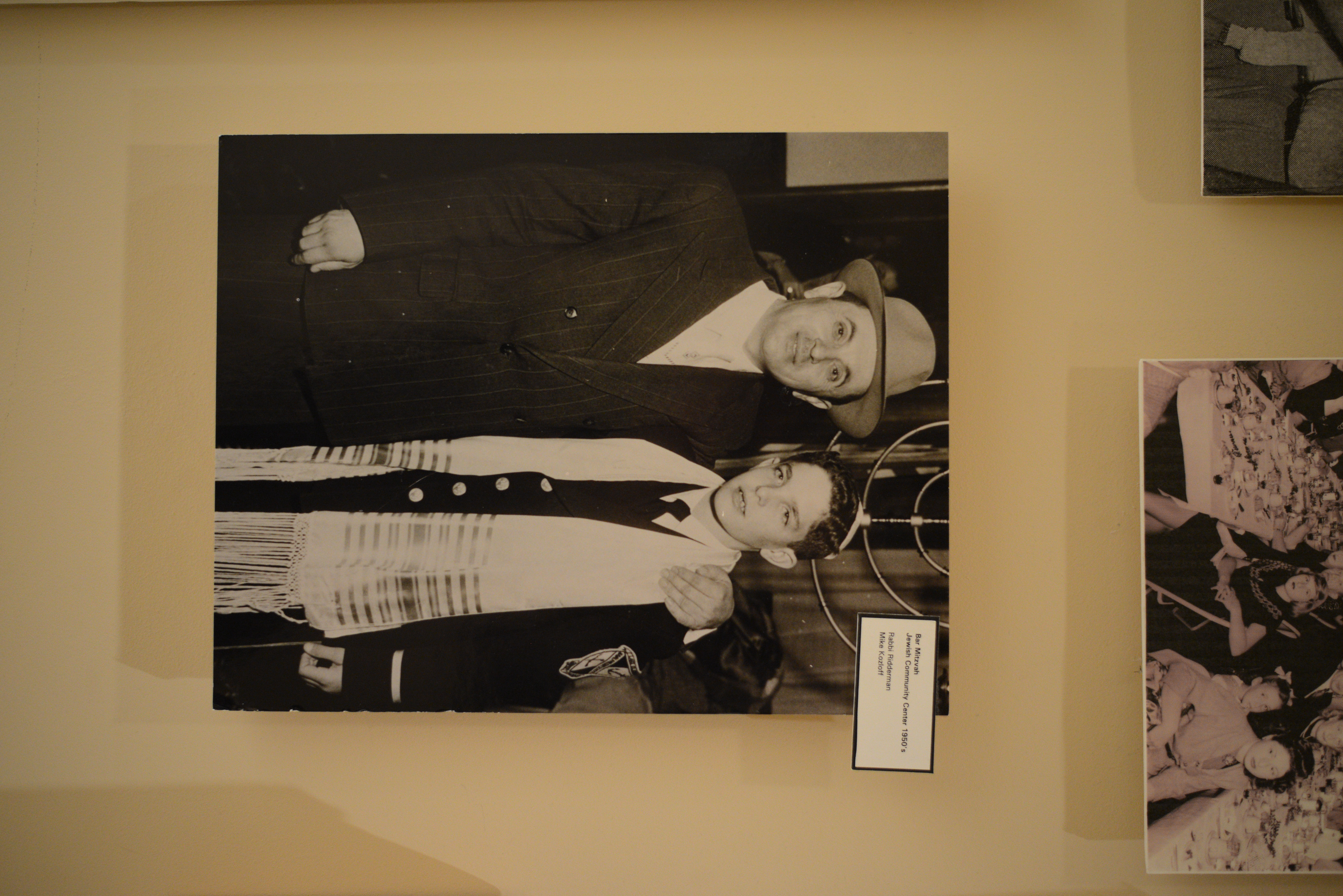 Photograph of Rabbi Ridderman and Mike Kozloff on his bar mitzvah at the Jewish Community Center, 1950s