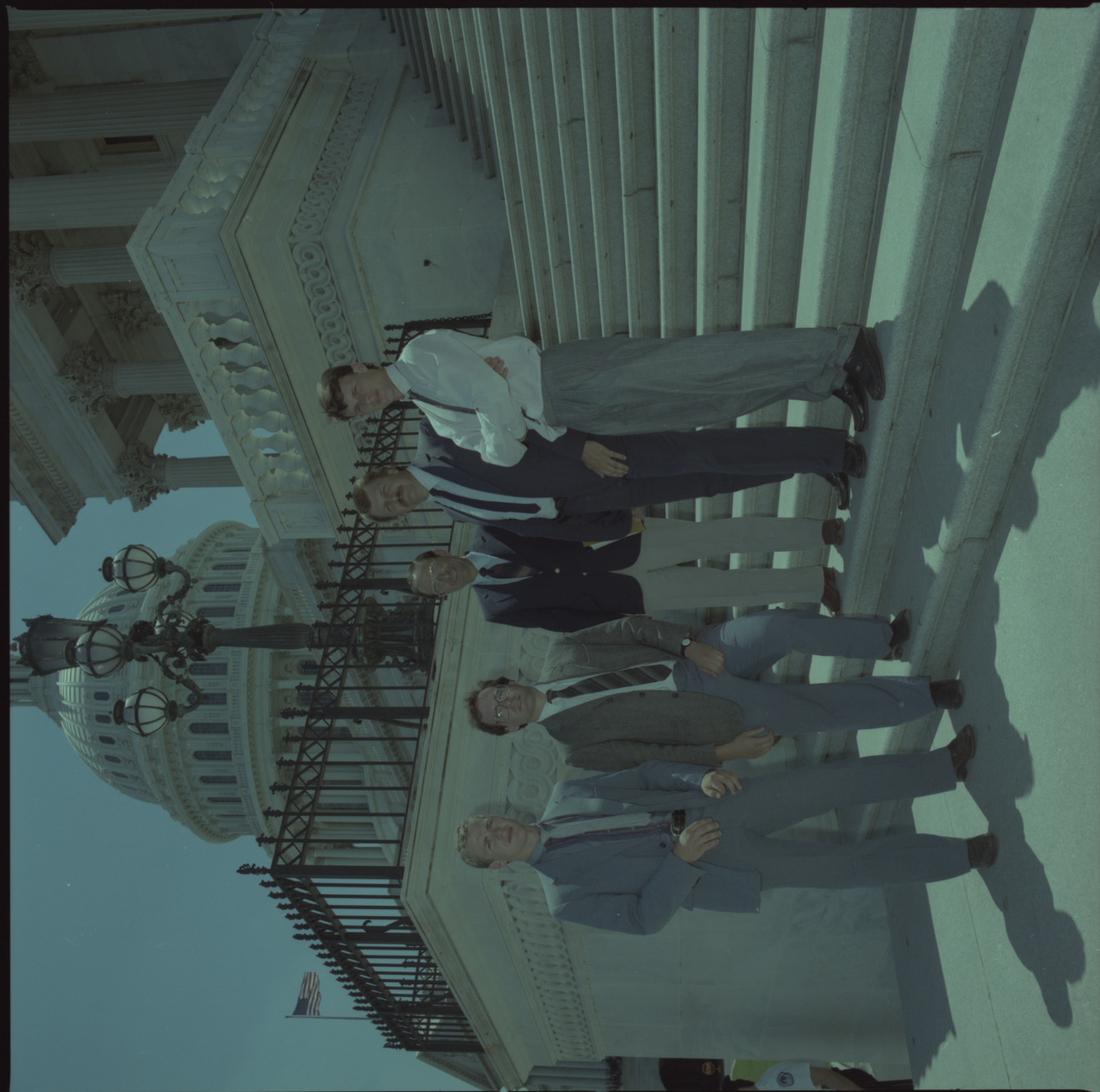 Film negative of group of people including Senator Chic Hecht standing on the Capitol steps, June 28, 1988