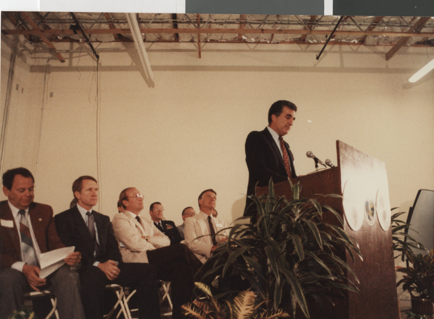 Photograph of Ron Lurie presenting at a podium, circa 1978