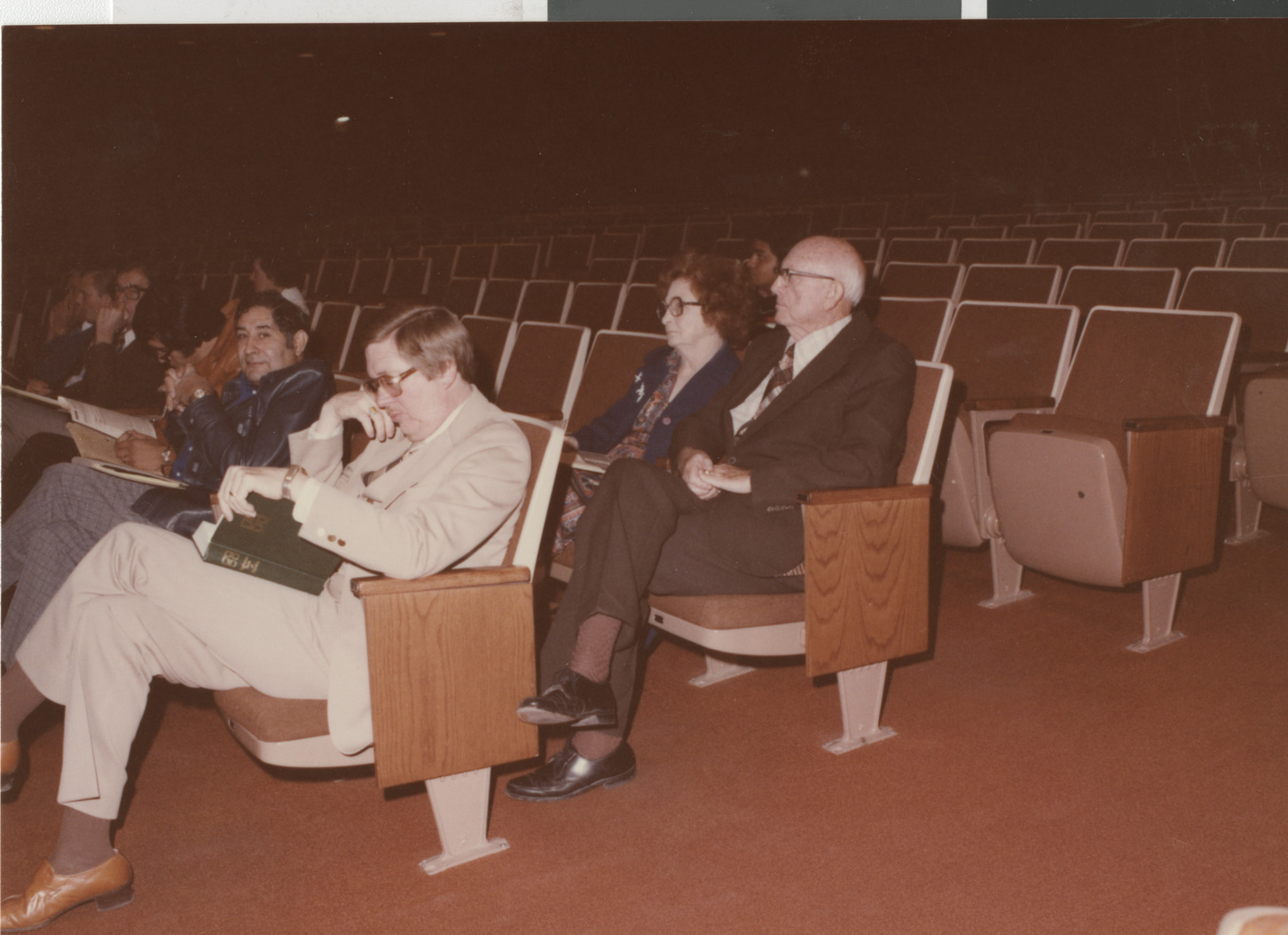 Photograph of people seated in an auditorium, circa 1978