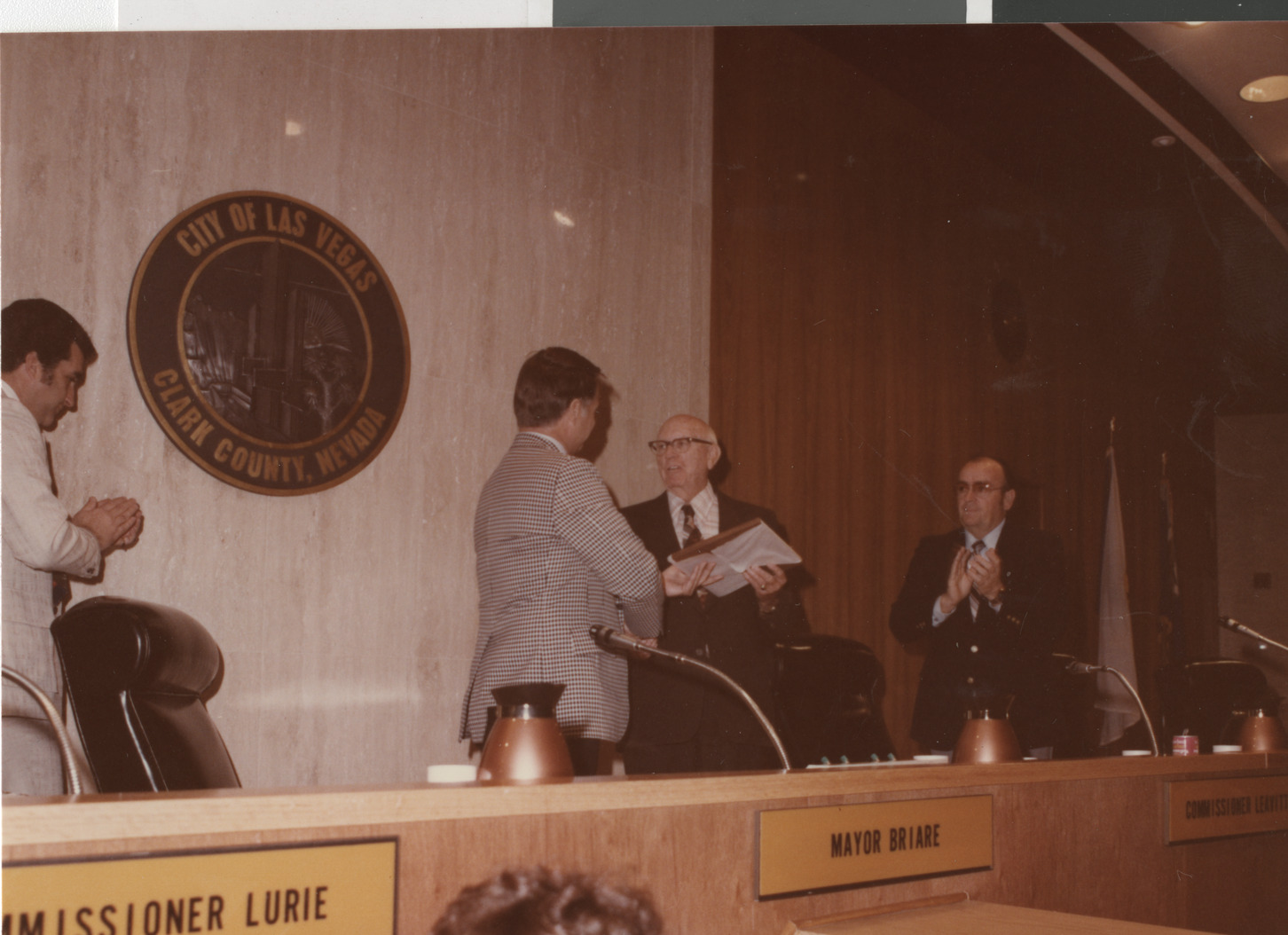 Photograph of Ron Lurie (left) and Mayor Briare presenting award, circa 1978