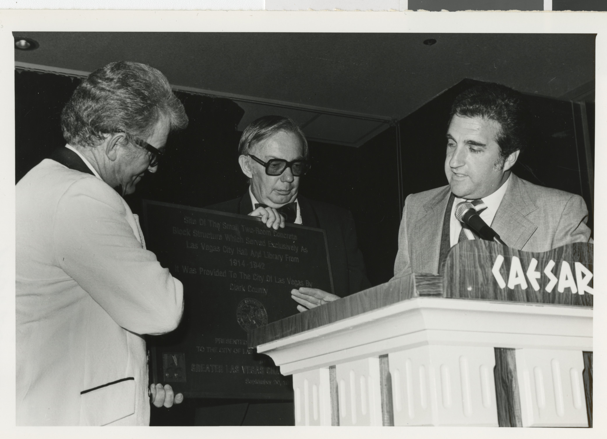 Photograph of Ron Lurie, City Commissioner, with plaque for the City Hall and Library building, circa 1978