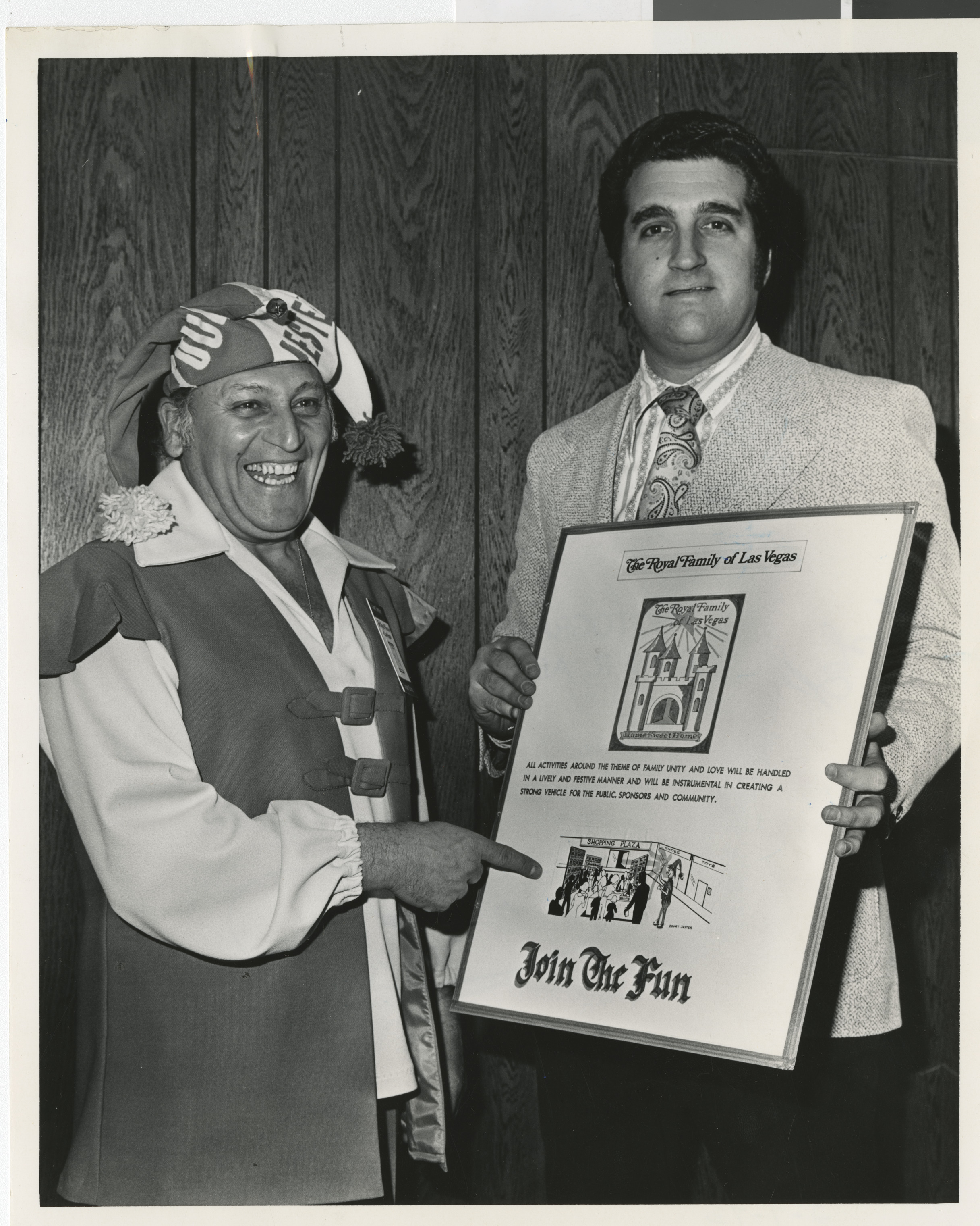 Photograph of Ron Lurie with a framed poster "The Royal Family of Las Vegas," circa 1978