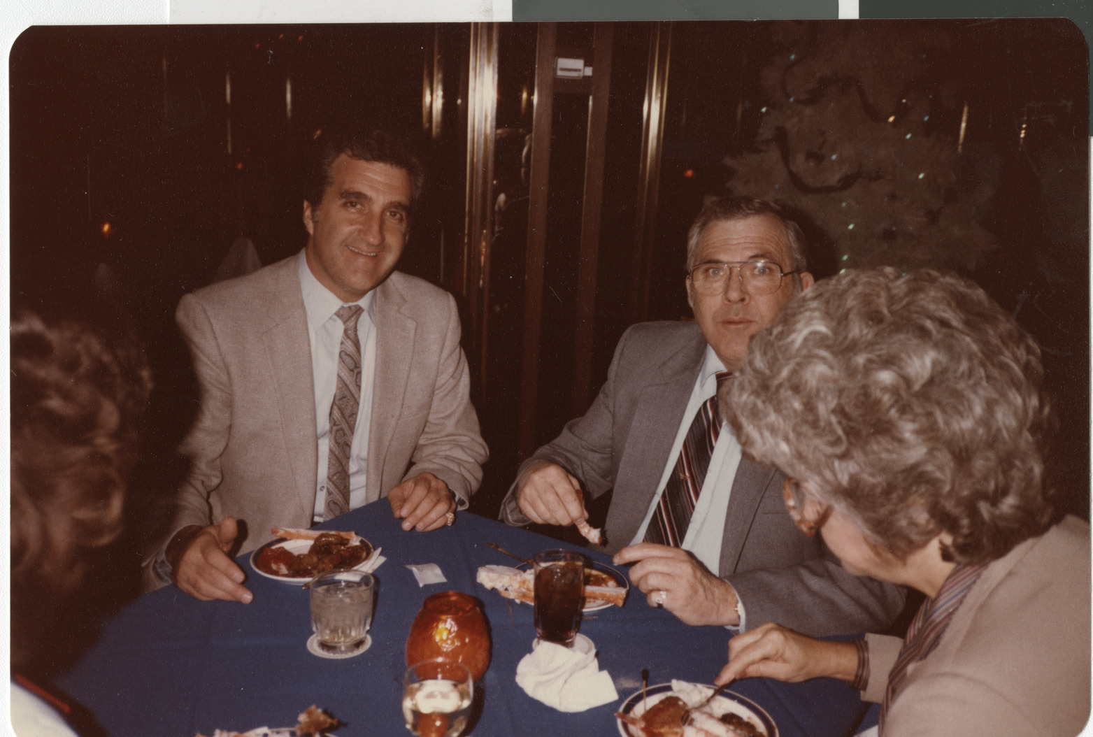 Photograph of Ron Lurie seated at a table with unidentified people