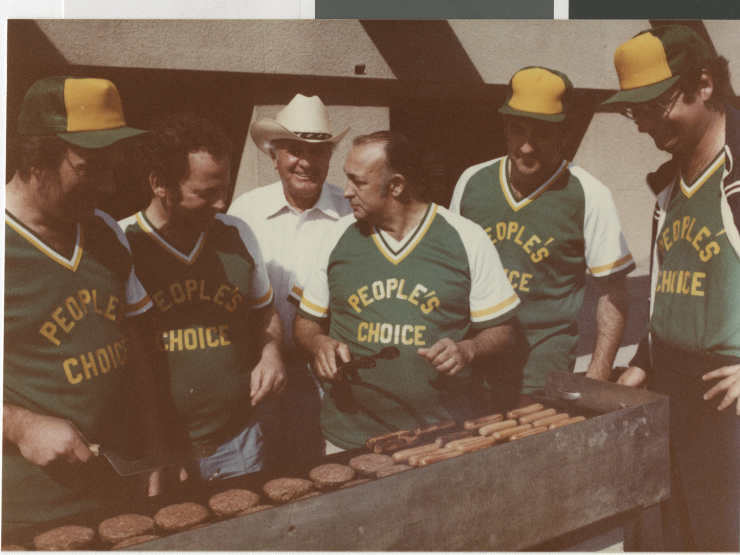 Photograph of Ron Lurie and others around a barbeque grill