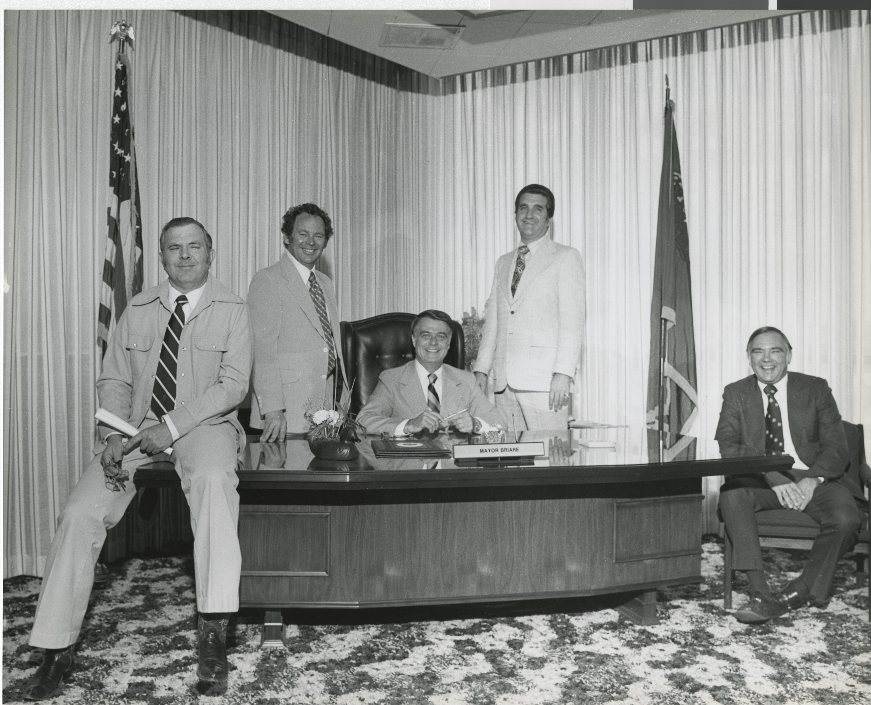 Photograph of Ron Lurie (standing right) with Mayor Briare and other council members