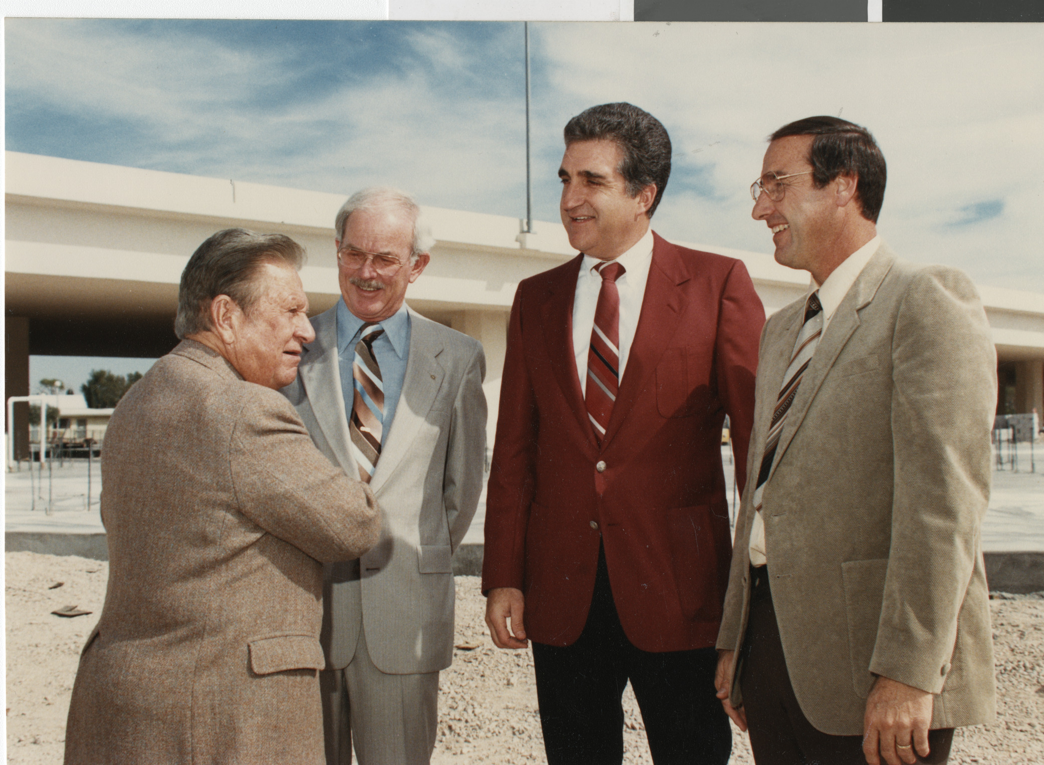 Photograph Ron Lurie (red jacket) and others near a highway overpass, circa 1980