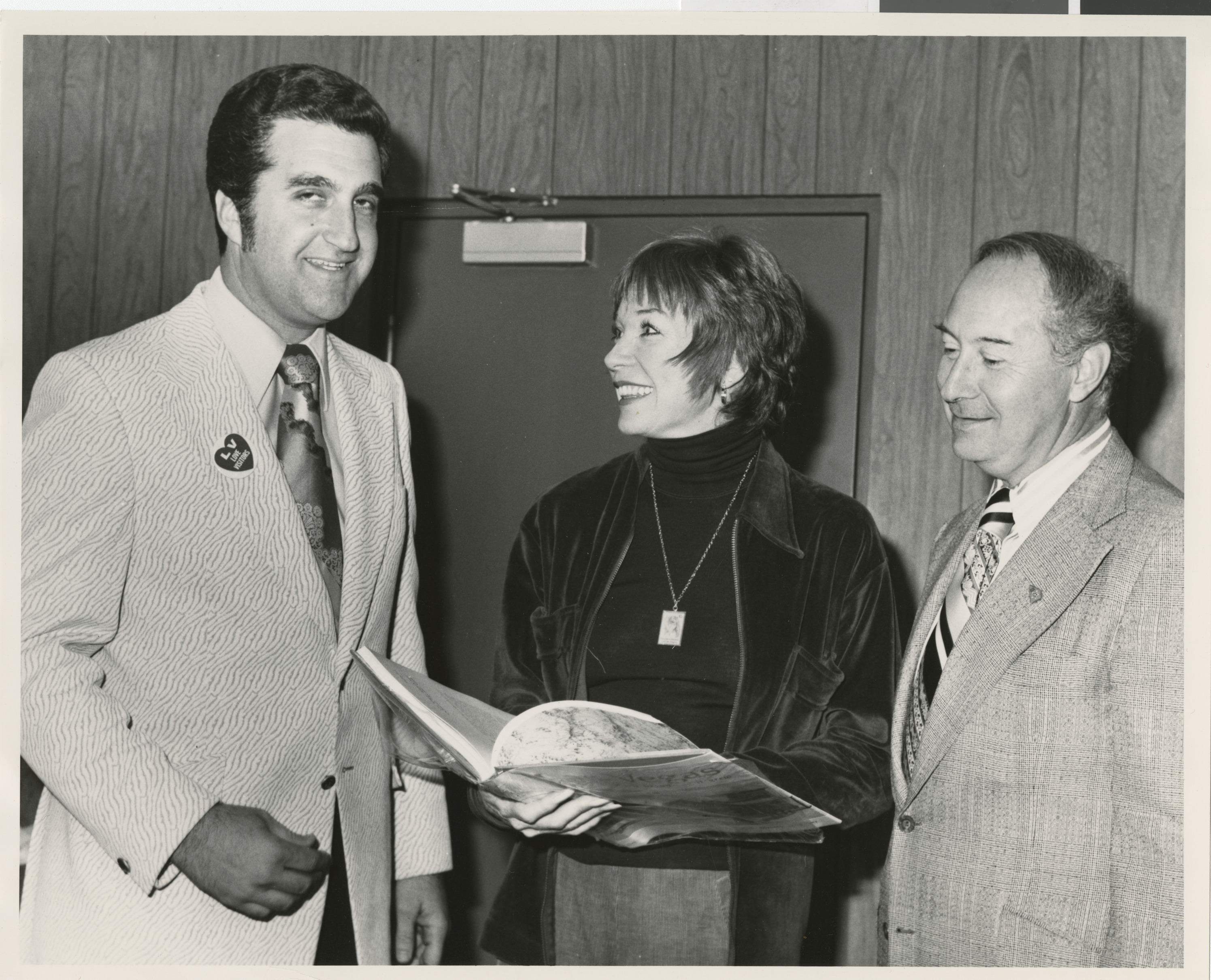 Photograph of Ron Lurie with unidentified couple