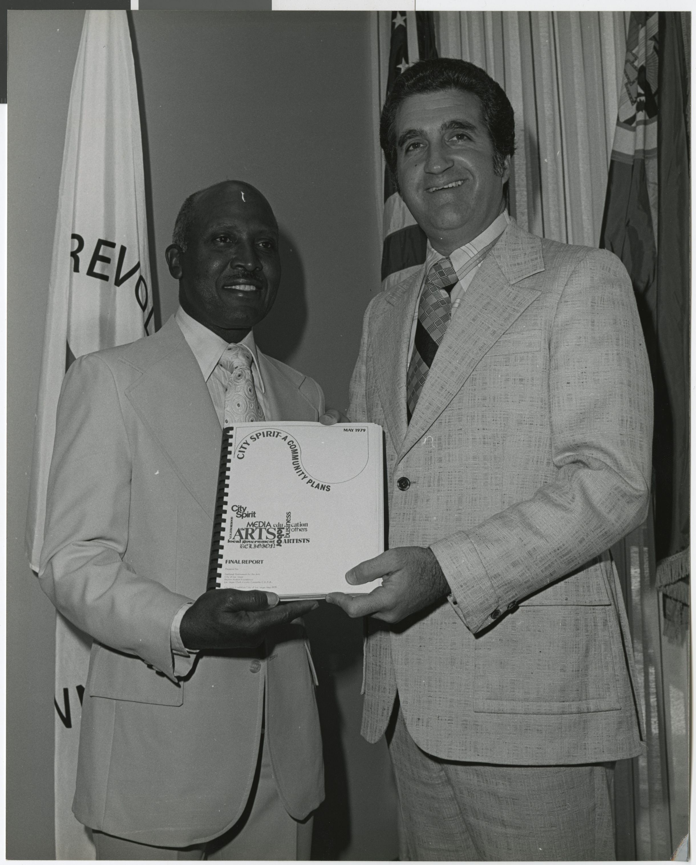 Photograph of Woodrow Wilson and Ron Lurie holding a City Spirit report, May 1979