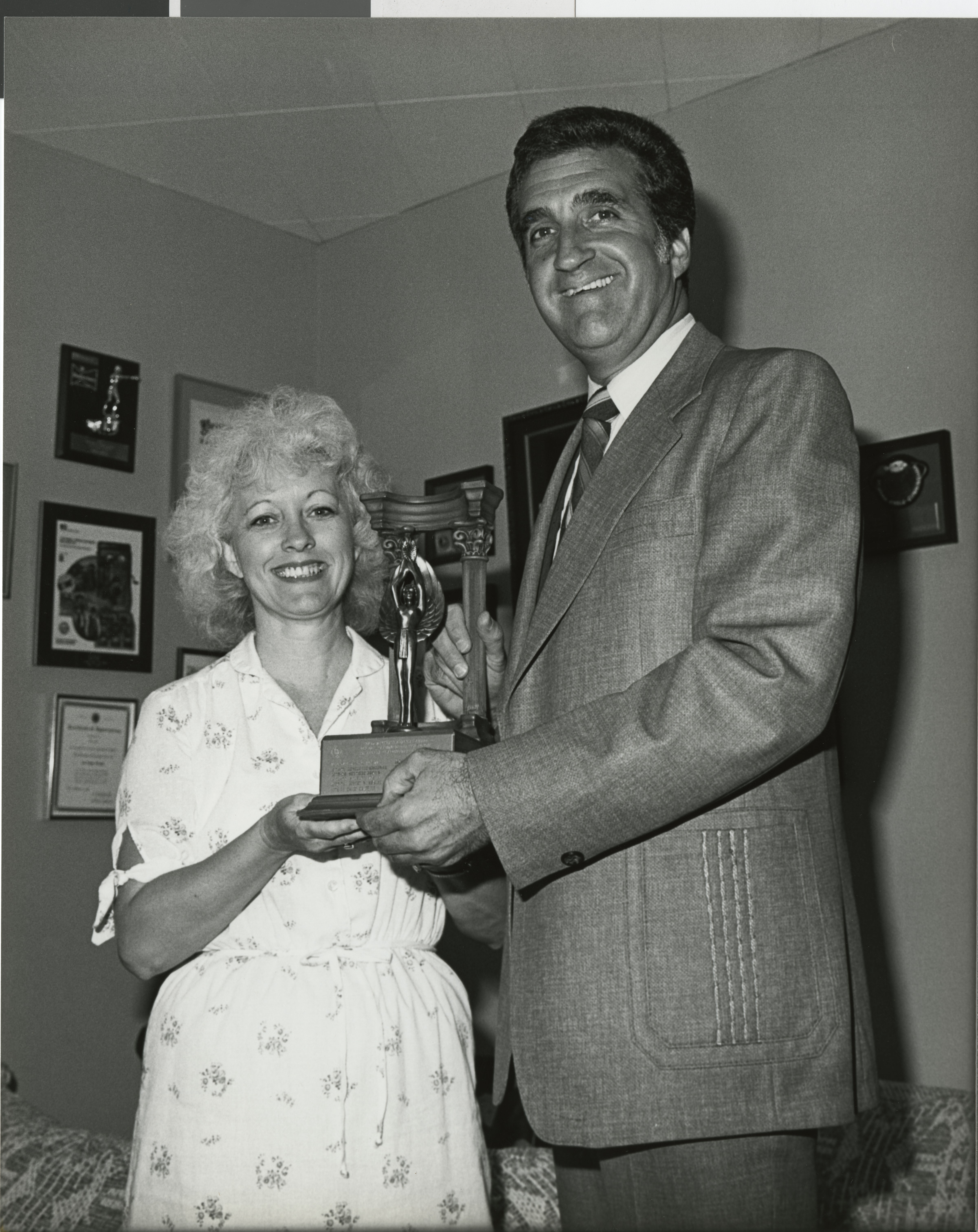 Photograph of Ron Lurie receiving the March of Dimes award from Mary Coon, Executive Director of March of Dimes, August 1982
