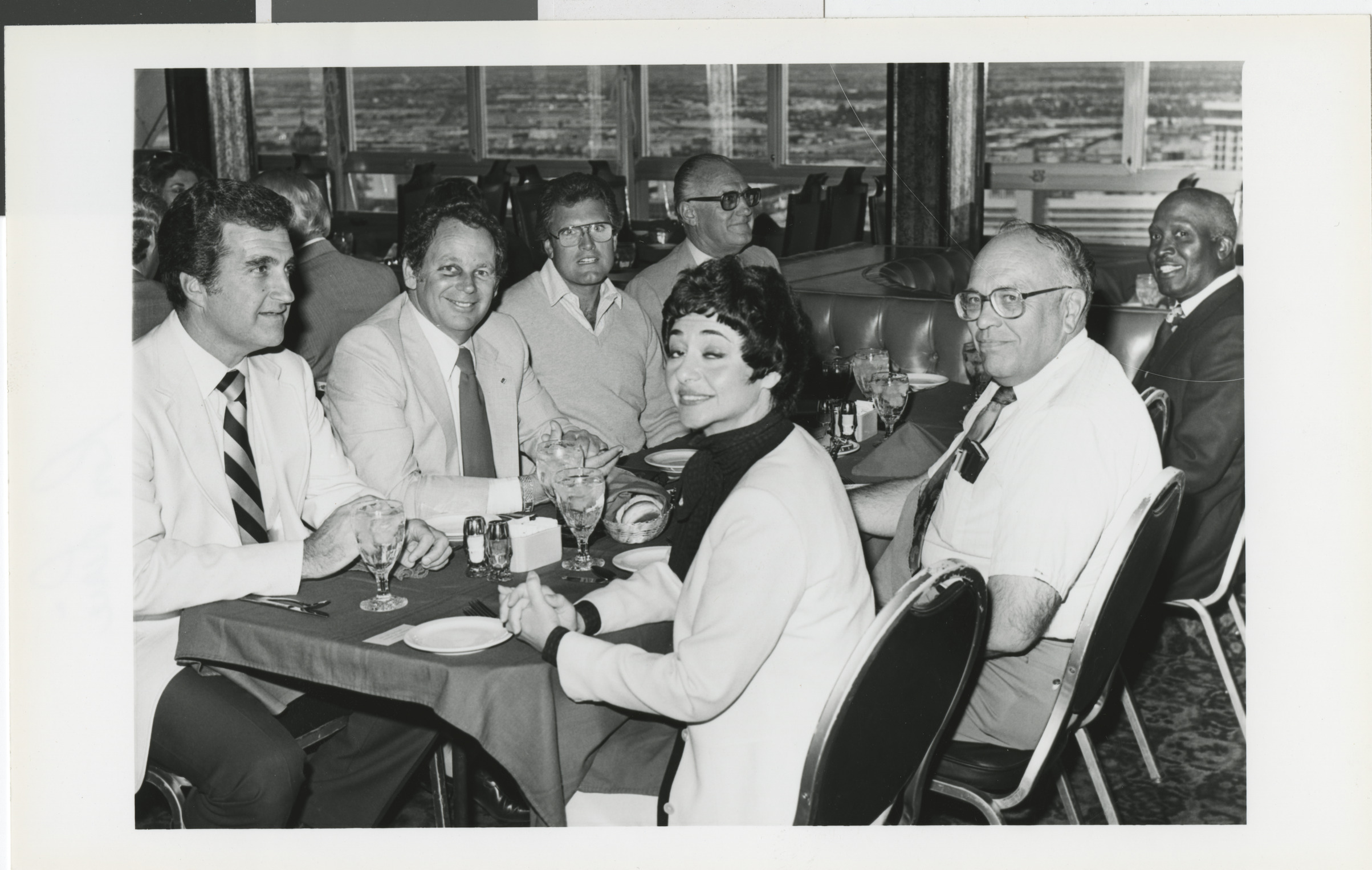 Photograph of Ron Lurie with a group at a restaurant (Woodrow Wilson at far right)