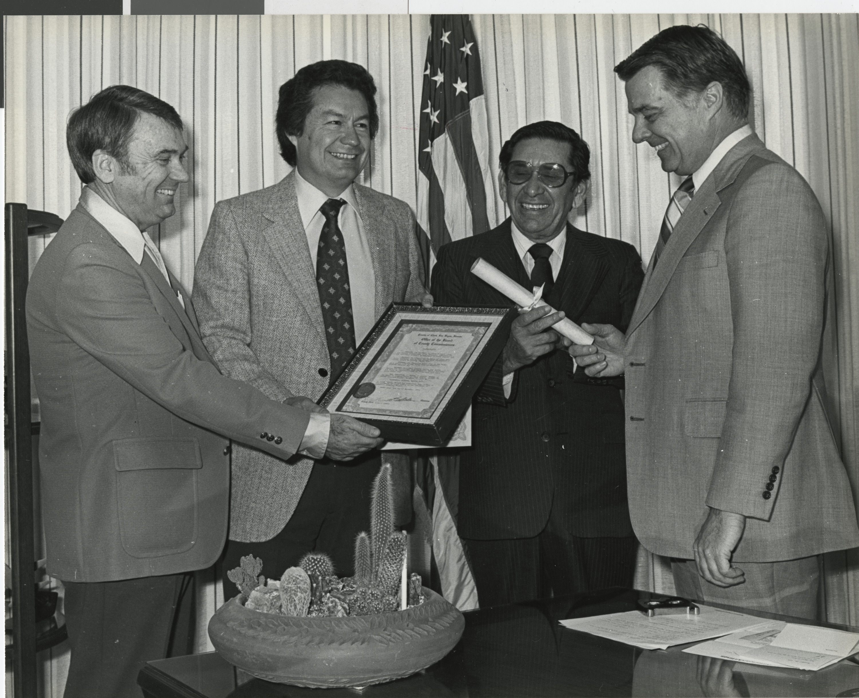 Photograph of Bill Briare (right) presenting certificate to a group of men