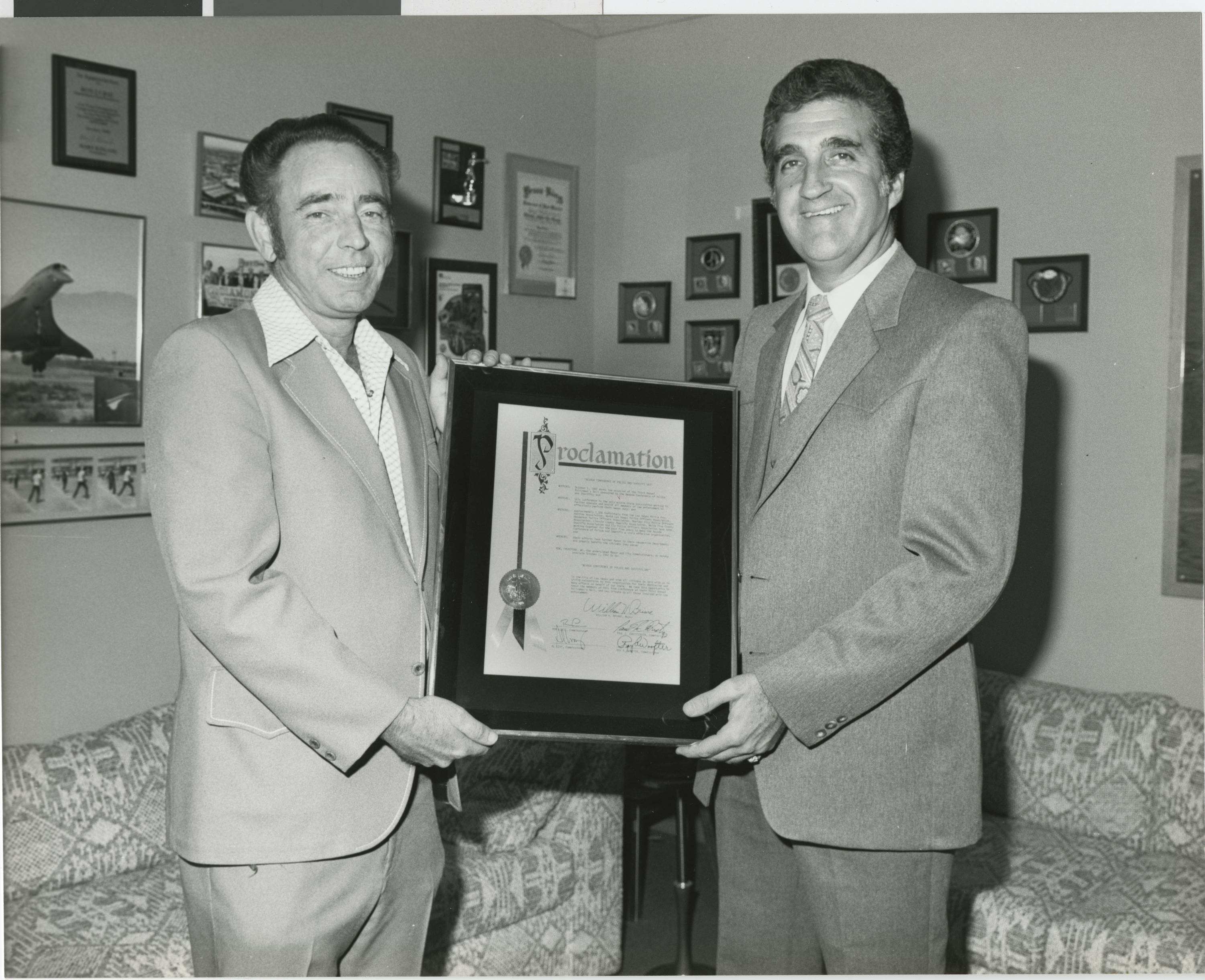 Photograph of Ron Lurie presenting a proclamation to O.C. Lee, October 1, 1982