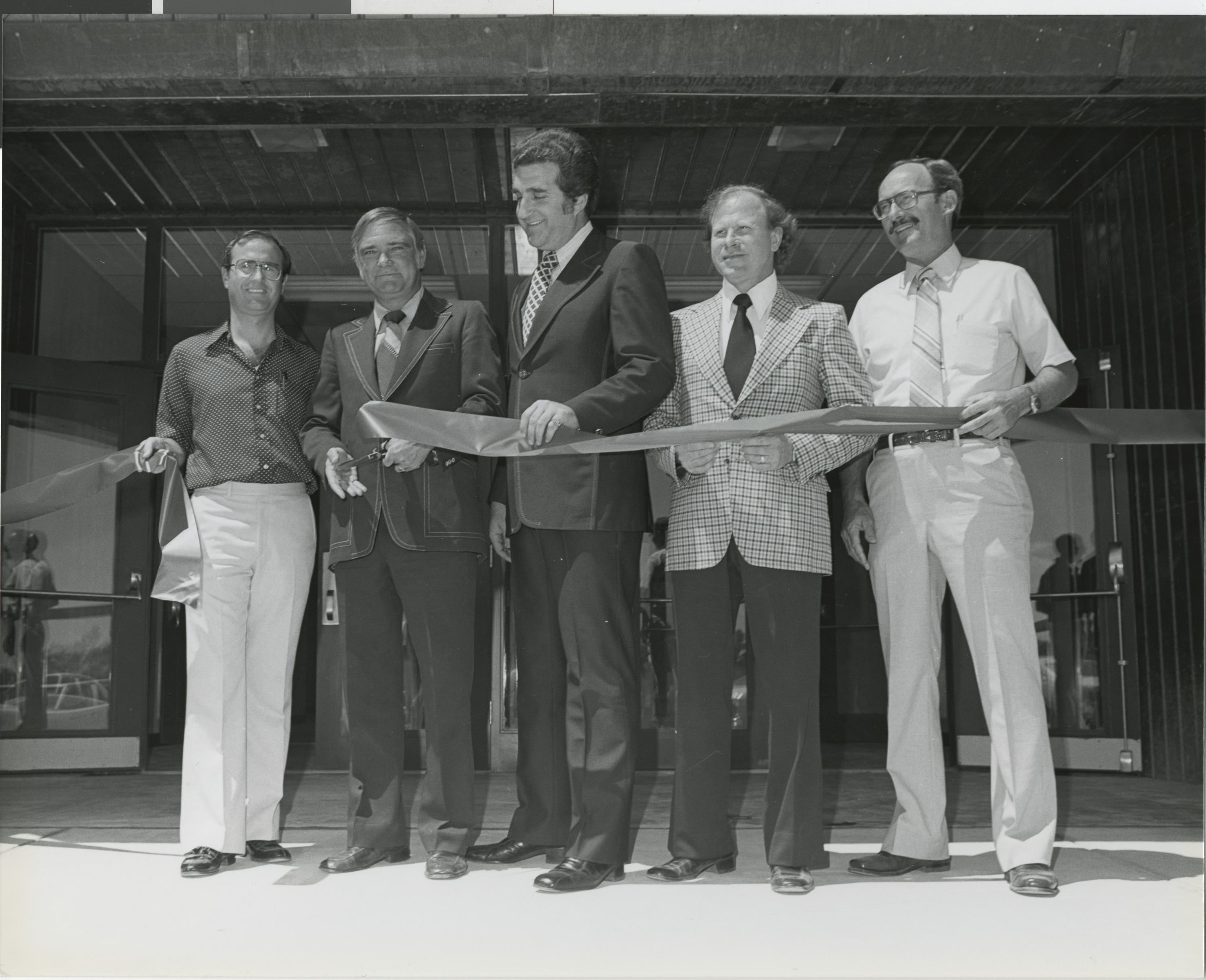 Photograph of Ron Lurie (center) at a ribbon cutting