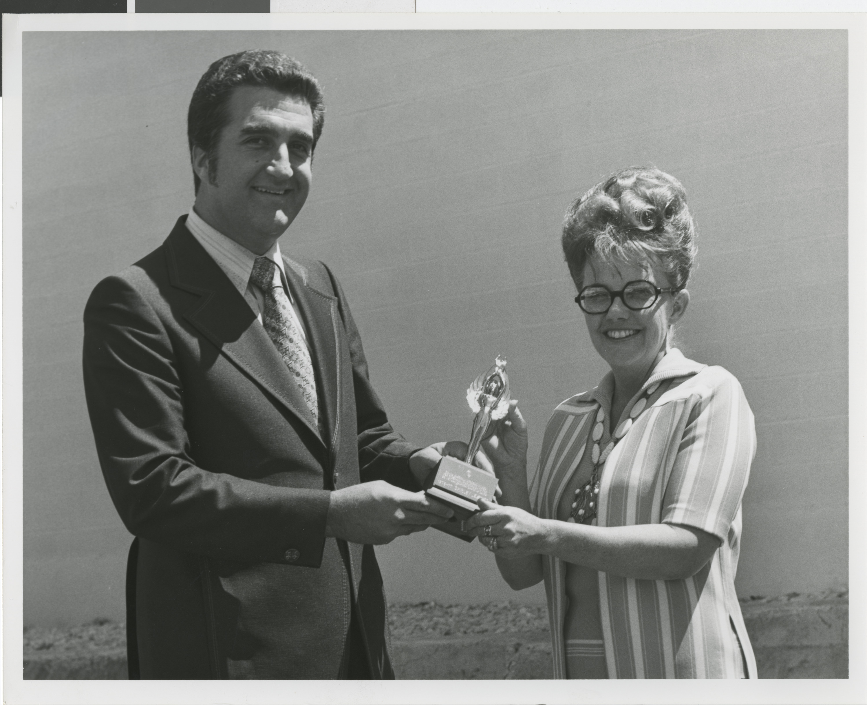 Photograph of Ron Lurie presenting a trophy