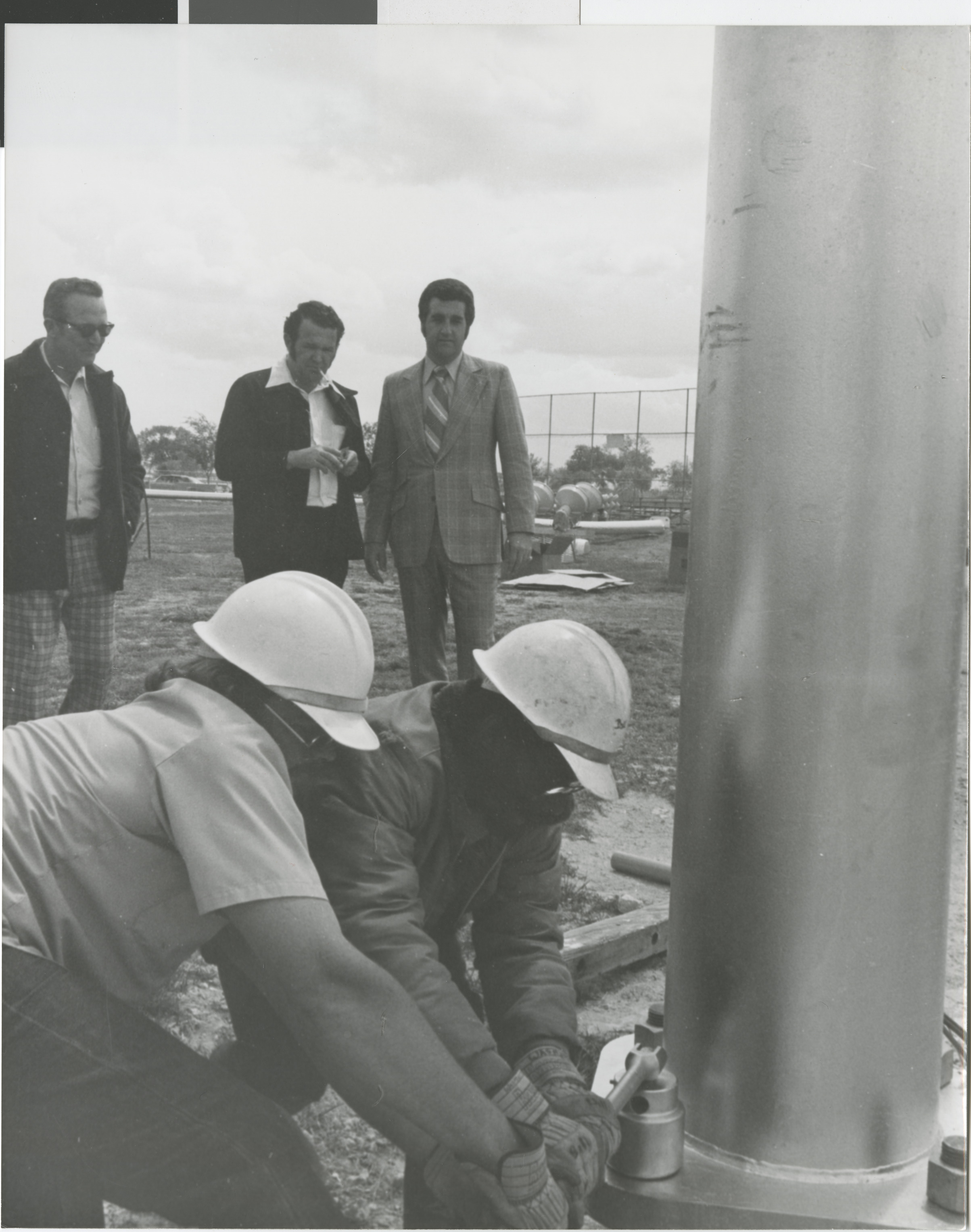 Photograph of Ron Lurie watches a light post installation