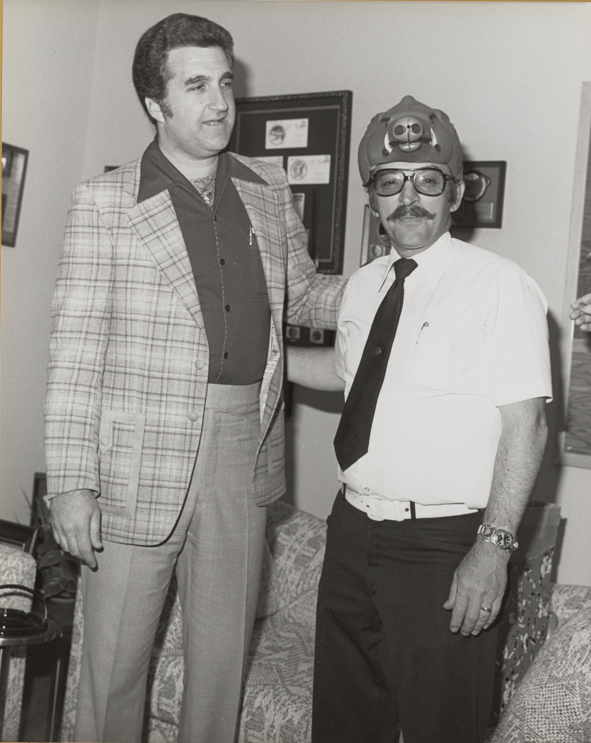 Photograph of Ron Lurie with a man wearing a pig hat