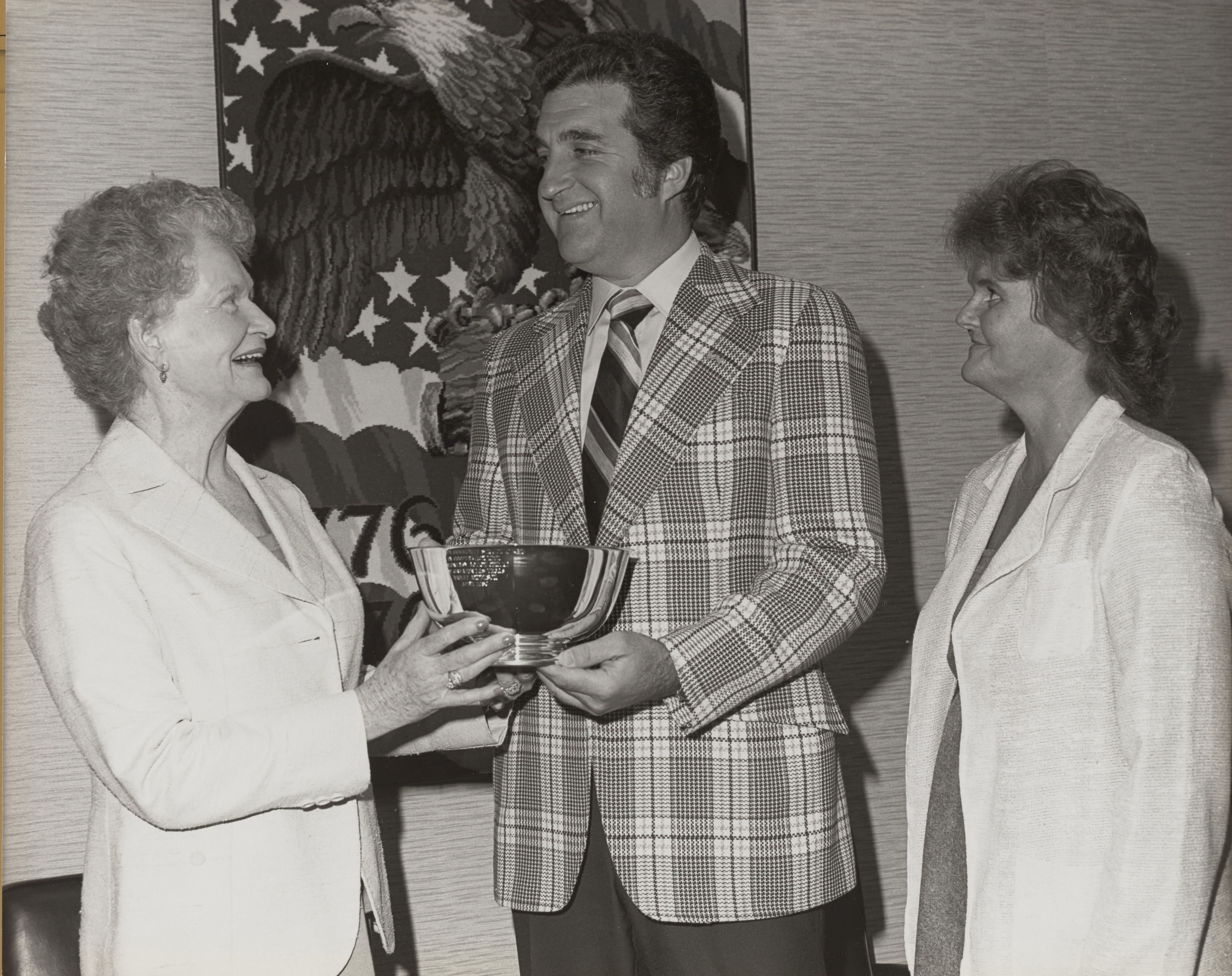 Photograph of Ron Lurie giving commemorative bowl to unidentified woman