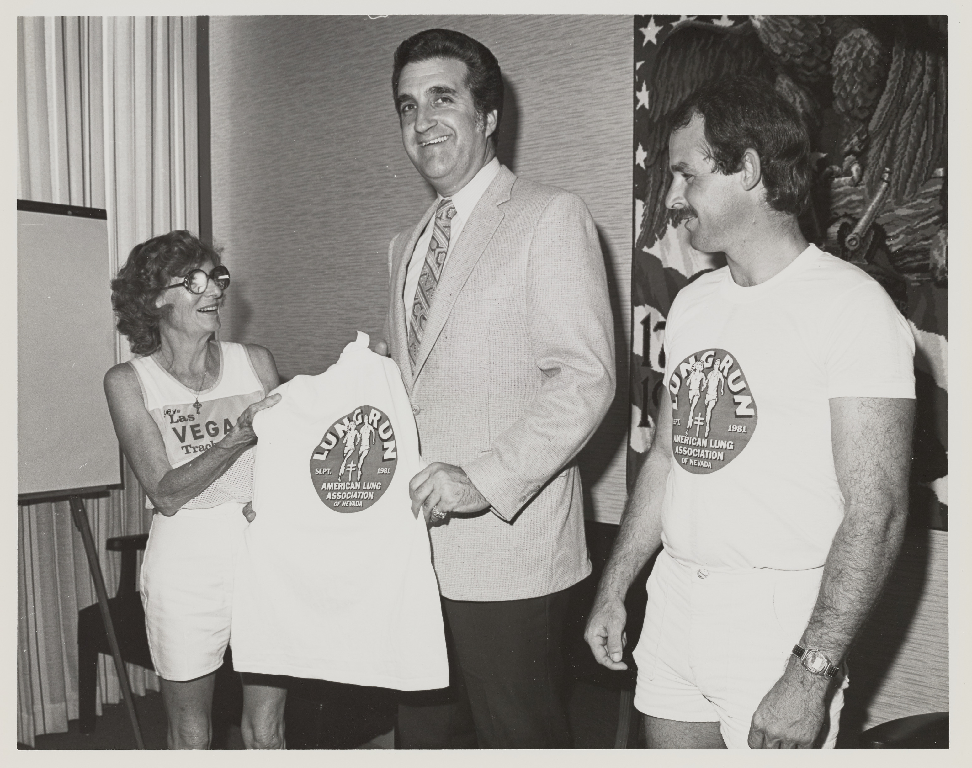 Photograph of Ron Lurie receiving Lung Run t-shirt