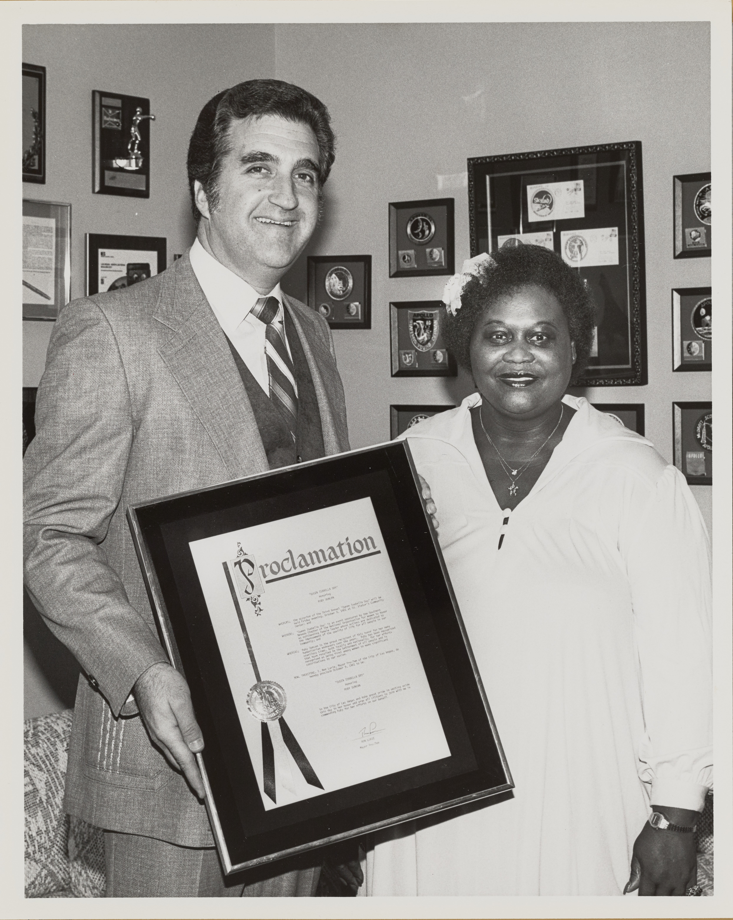 Photograph of Ron Lurie with Proclamation for Joan Isabella Day, presentation to Ruby Duncan, October 7, 1981