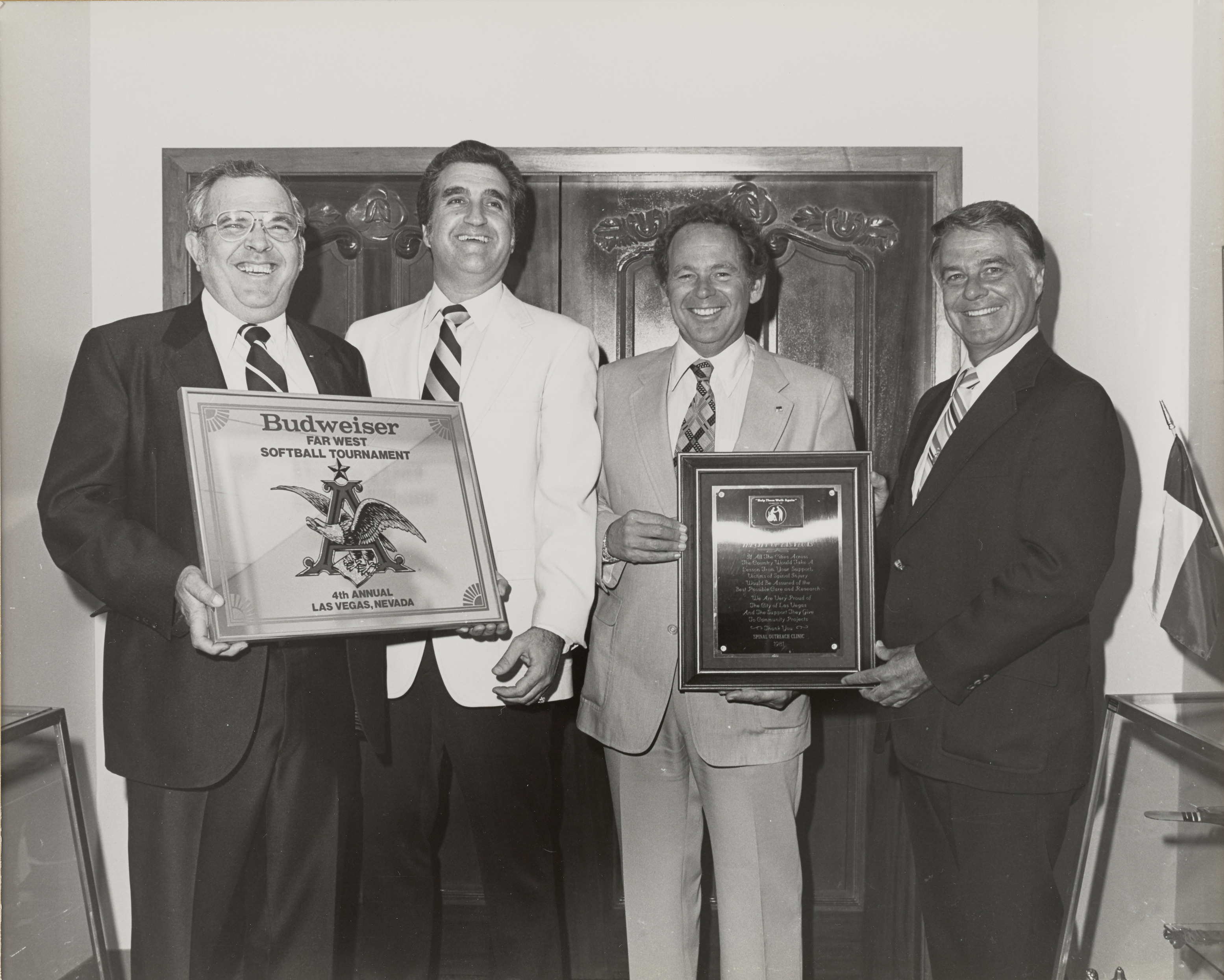 Photograph of Ron Lurie, Mayor Briare and others with plaques for a softball tournament