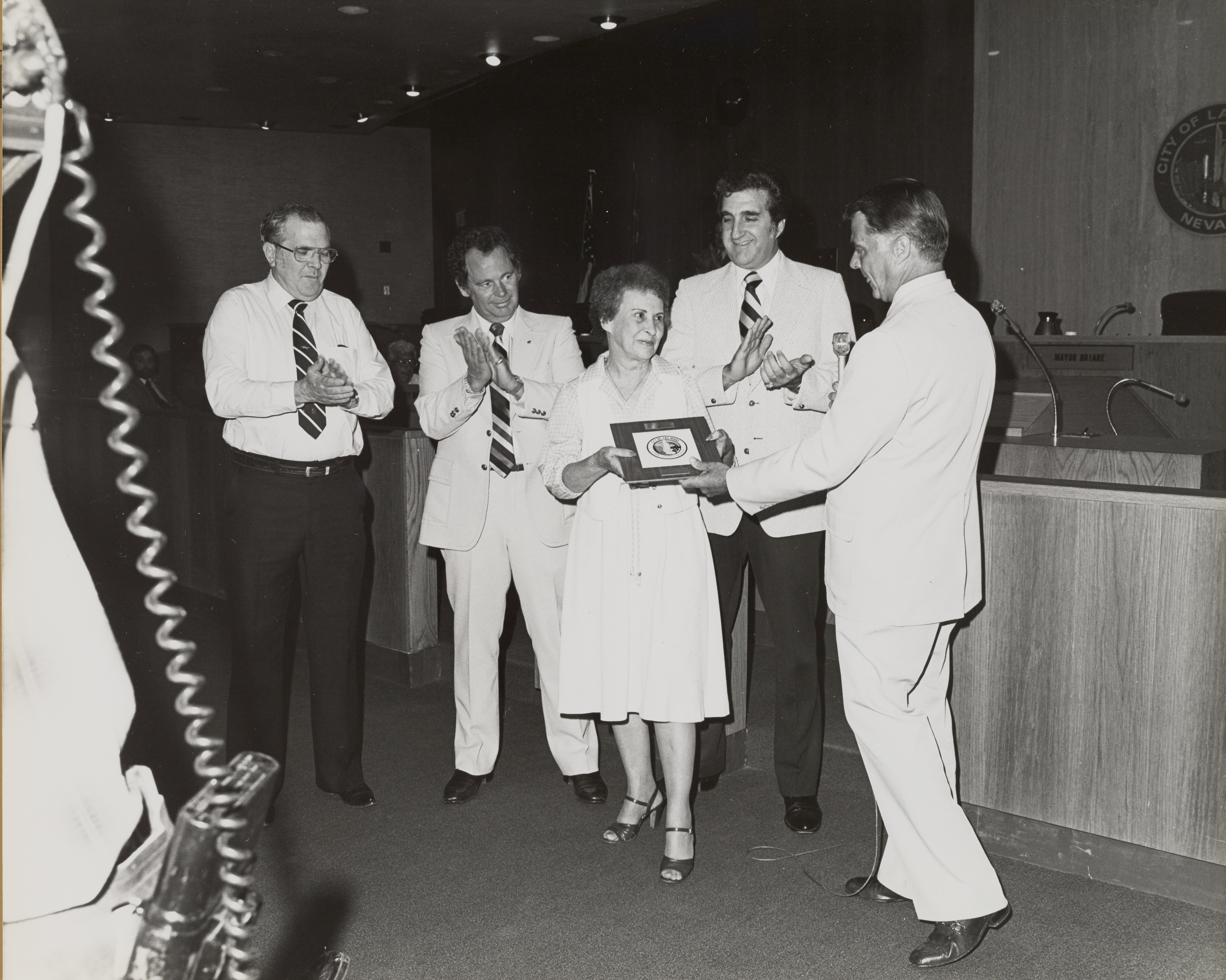 Photograph of Mayor Briare, Ron Lurie and others giving retirement award to Ila Britt, Director for the Department of Business Activity, September 2, 1981